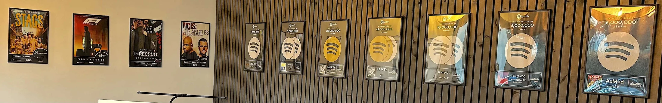Panorama of Spotify awards and sync references displayed at KAA Production